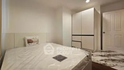 Modern bedroom with sleek wardrobe and cozy bed in minimalist design.