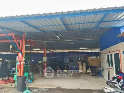 Spacious industrial warehouse with ample storage and work area, featuring a sturdy metal roof and open layout.