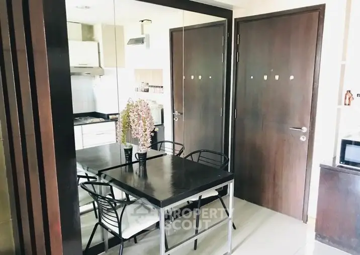Modern kitchen with open layout, sleek black dining set, and ample natural light, perfect for culinary enthusiasts seeking a stylish cooking space.