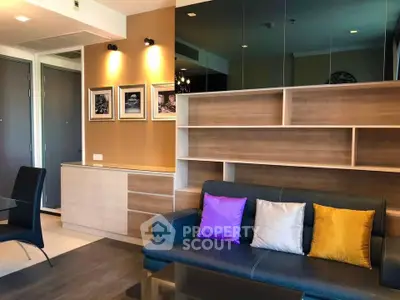 Modern living room with stylish shelving and colorful cushions in a contemporary apartment.