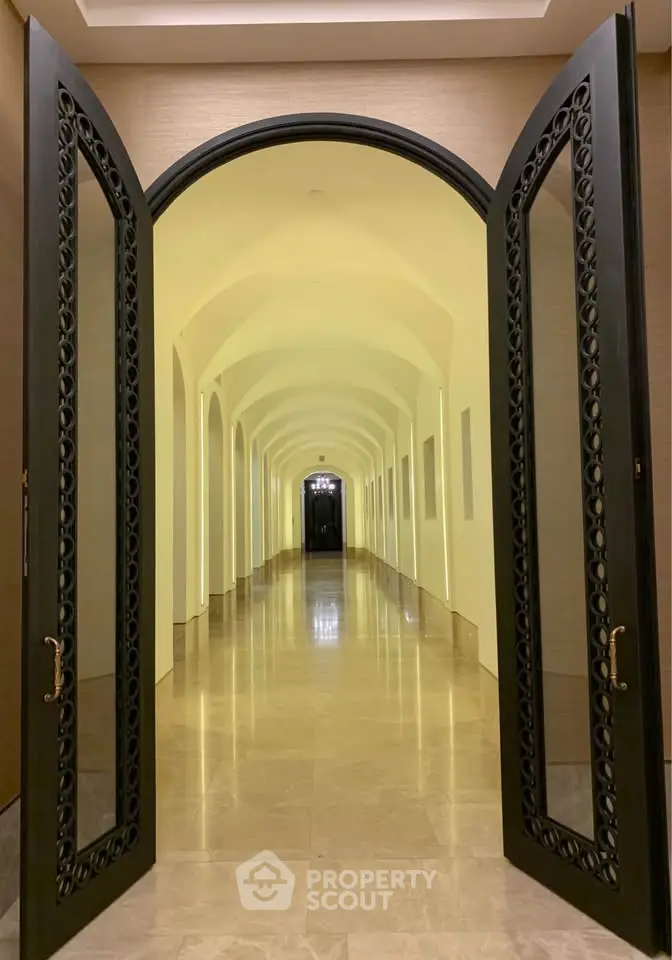 Elegant corridor with arched doorways and polished marble floors in luxury building