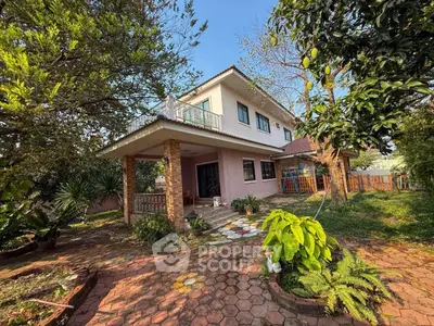 Charming two-story house with lush garden and spacious patio