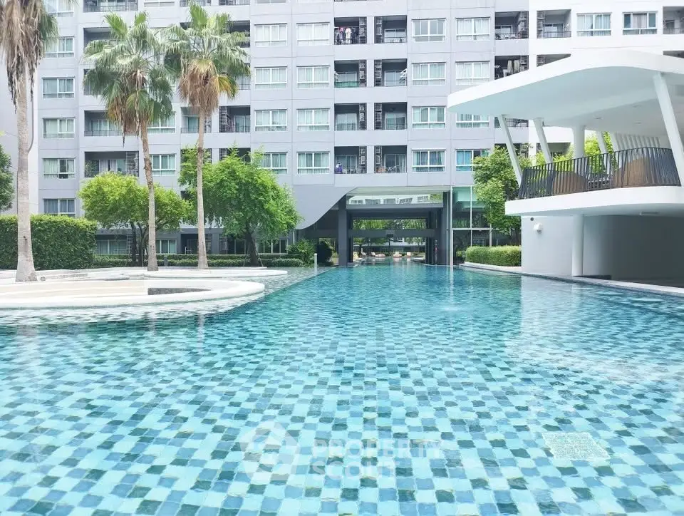 Luxurious apartment complex with stunning pool and modern architecture.