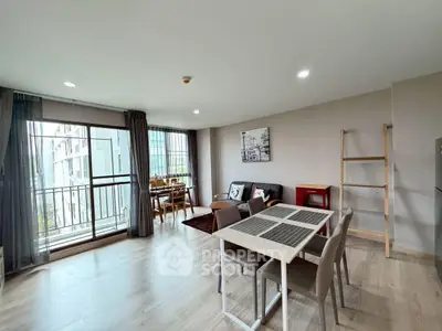 Spacious modern living room with dining area and large windows in urban apartment