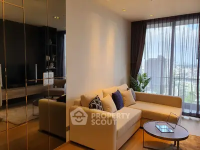 Modern living room with large windows and city view, featuring a cozy beige sofa and stylish decor.