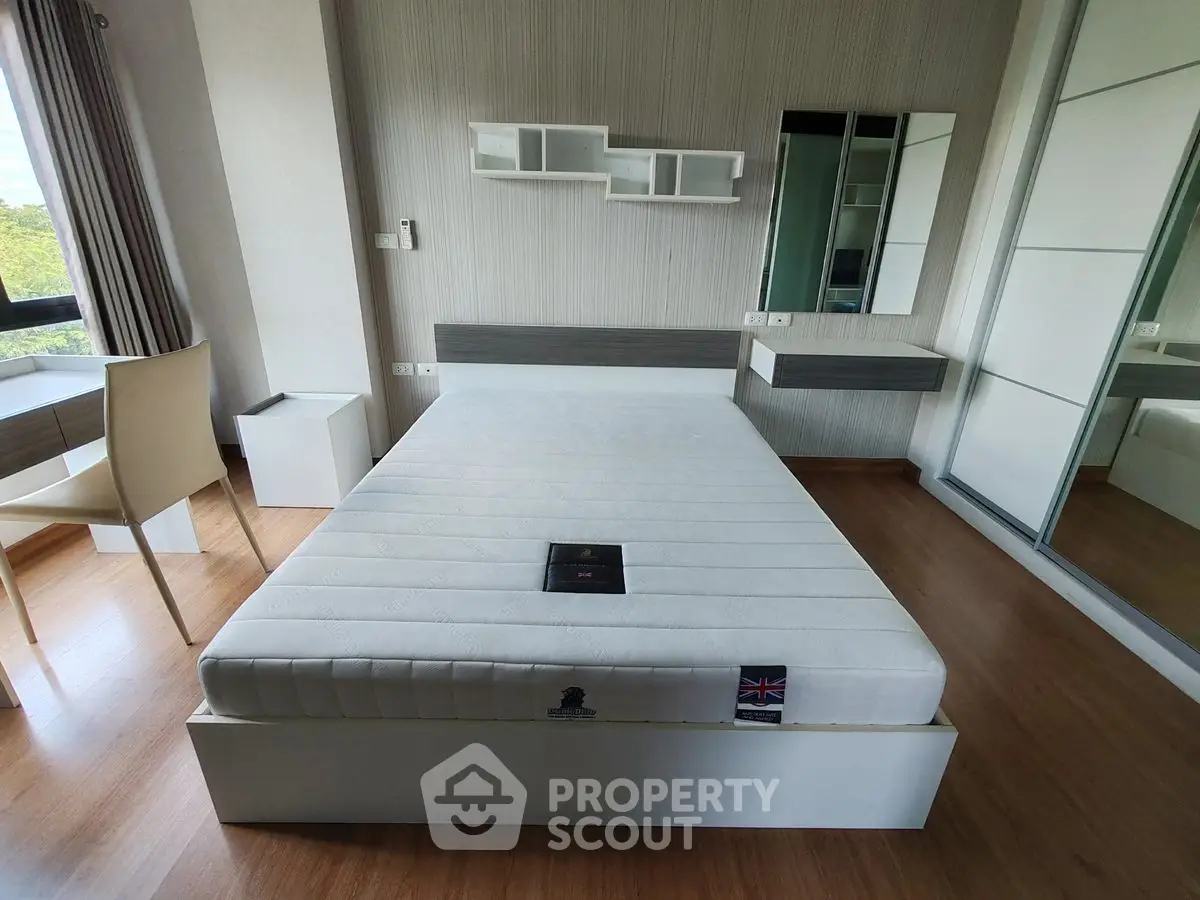 Modern bedroom with stylish furniture and large window view