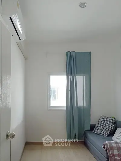 Cozy small room with window, sofa, and air conditioning unit