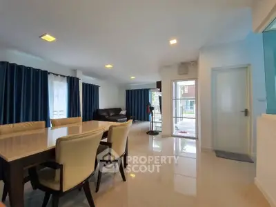 Spacious modern living room with elegant dining area and large windows