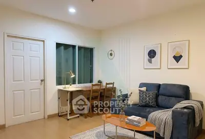 Cozy living room with modern decor and study area, perfect for relaxation and productivity.