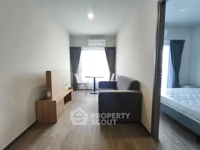 Modern apartment interior with cozy living room and bedroom, featuring stylish furniture and natural light.