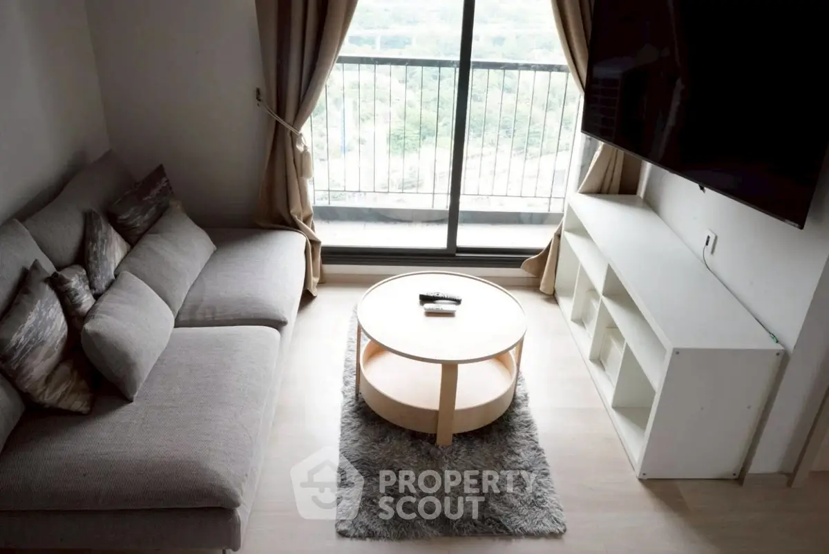 Modern living room with cozy sofa and balcony view