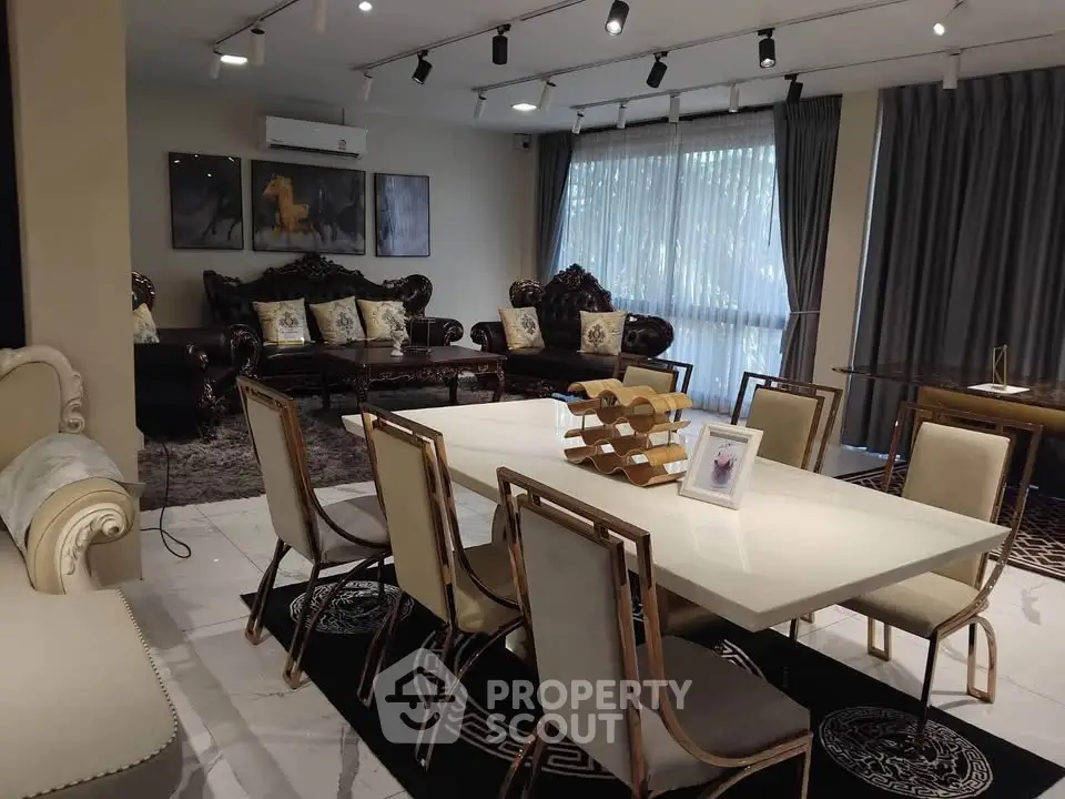 Luxurious living and dining area with elegant furniture and large windows for natural light.