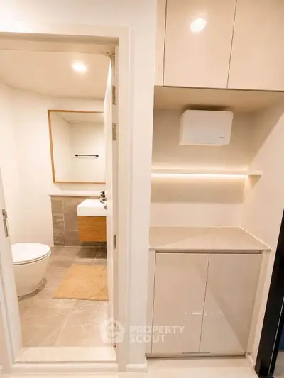 Modern bathroom with sleek cabinetry and elegant fixtures in a contemporary apartment.