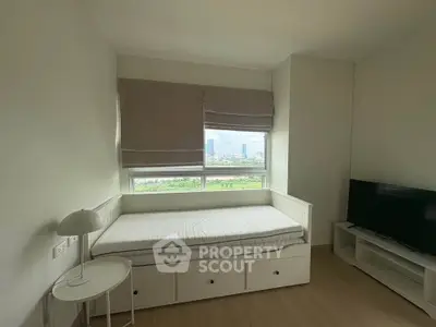 Cozy bedroom with daybed and city view, perfect for urban living.