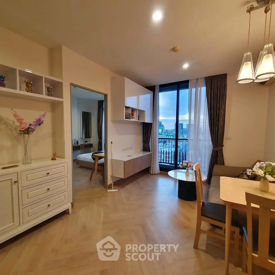Modern living room with dining area and city view balcony