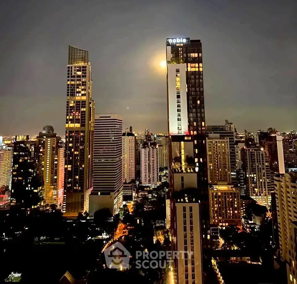 Stunning cityscape view with illuminated skyscrapers at night, showcasing urban living.
