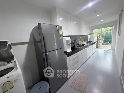 Modern kitchen with sleek appliances and garden view