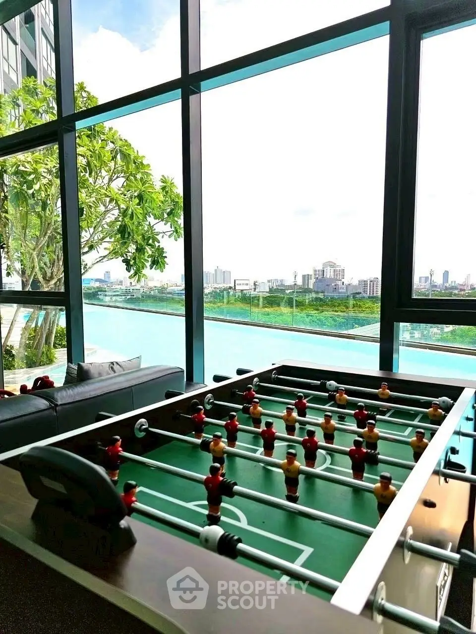 Luxurious high-rise apartment with stunning city view and foosball table