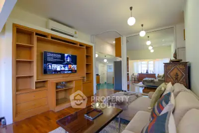 Spacious living room with modern decor and built-in entertainment center