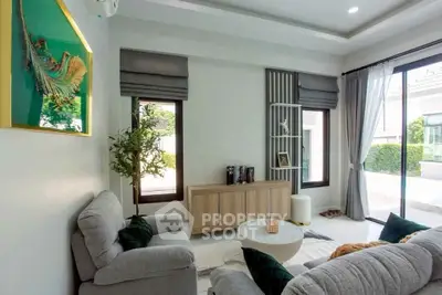 Modern living room with stylish decor and large windows offering natural light and garden view.