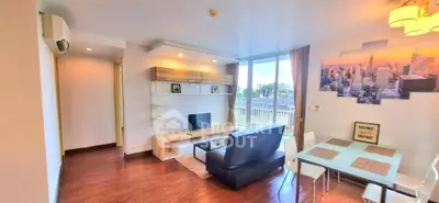Modern living room with stylish decor and large windows offering natural light.