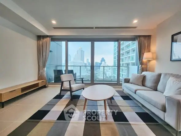 Spacious living room with city view, modern furniture, and large windows.