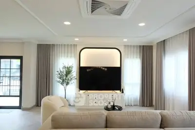 Spacious modern living room with elegant decor and large windows