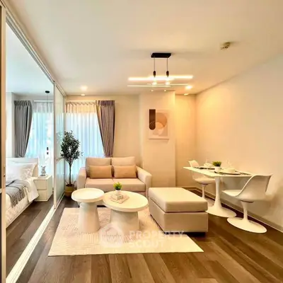 Modern living room with stylish furniture and open layout, featuring a cozy dining area and elegant decor.