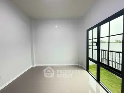 Spacious empty room with large windows and garden view, perfect for customization.