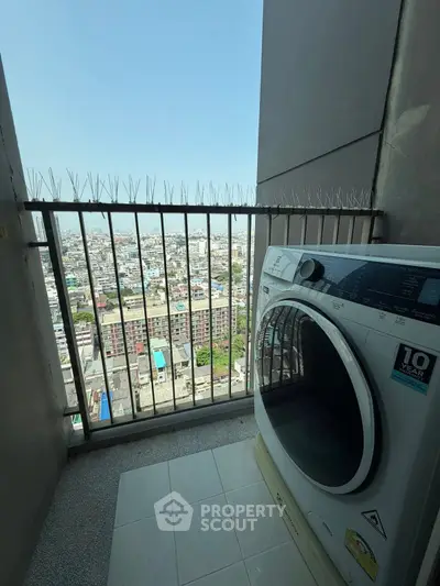 High-rise balcony with city view and modern washing machine