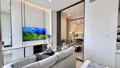 Modern living room with sleek design and open kitchen layout