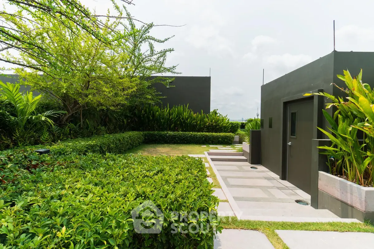 Modern rooftop garden with lush greenery and sleek design elements.