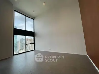 Spacious modern living room with high ceilings and city view