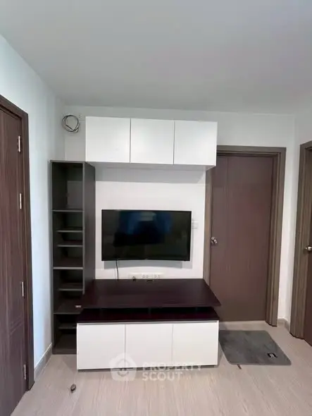 Modern living room with sleek TV unit and storage cabinets, perfect for contemporary living.