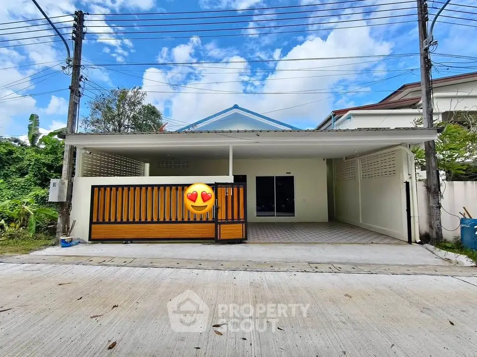 Charming single-story home with spacious carport and modern facade, perfect for family living.