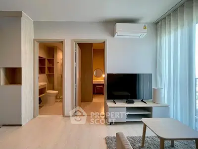 Modern living room with TV, air conditioning, and open bathroom view.