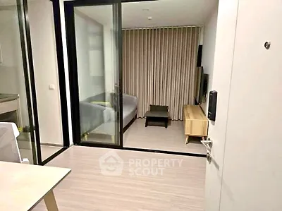 Modern apartment interior with sliding glass doors and cozy living area