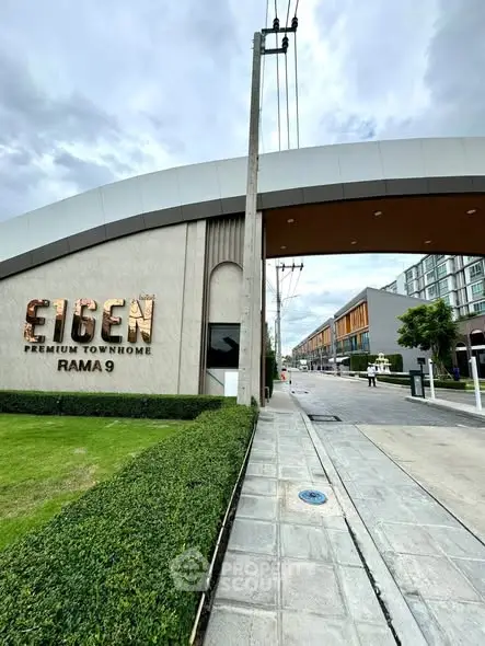 Modern townhome entrance with sleek design and lush greenery at Eigen Premium Townhome Rama 9.