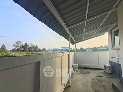 Spacious balcony with scenic view and modern awning in suburban home