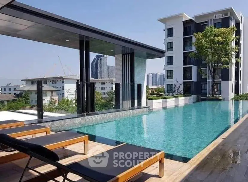 Luxurious rooftop pool with stunning city views and modern apartment building.