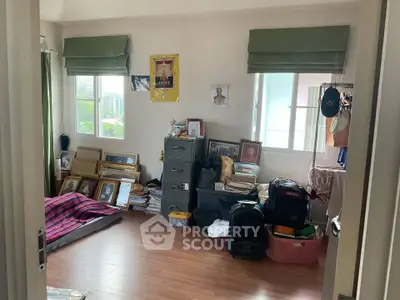 Cozy room with wooden flooring, ample natural light, and organized storage space, ideal for creative living.