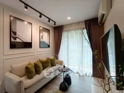 Stylish living room with modern decor, large windows, and cozy seating area.