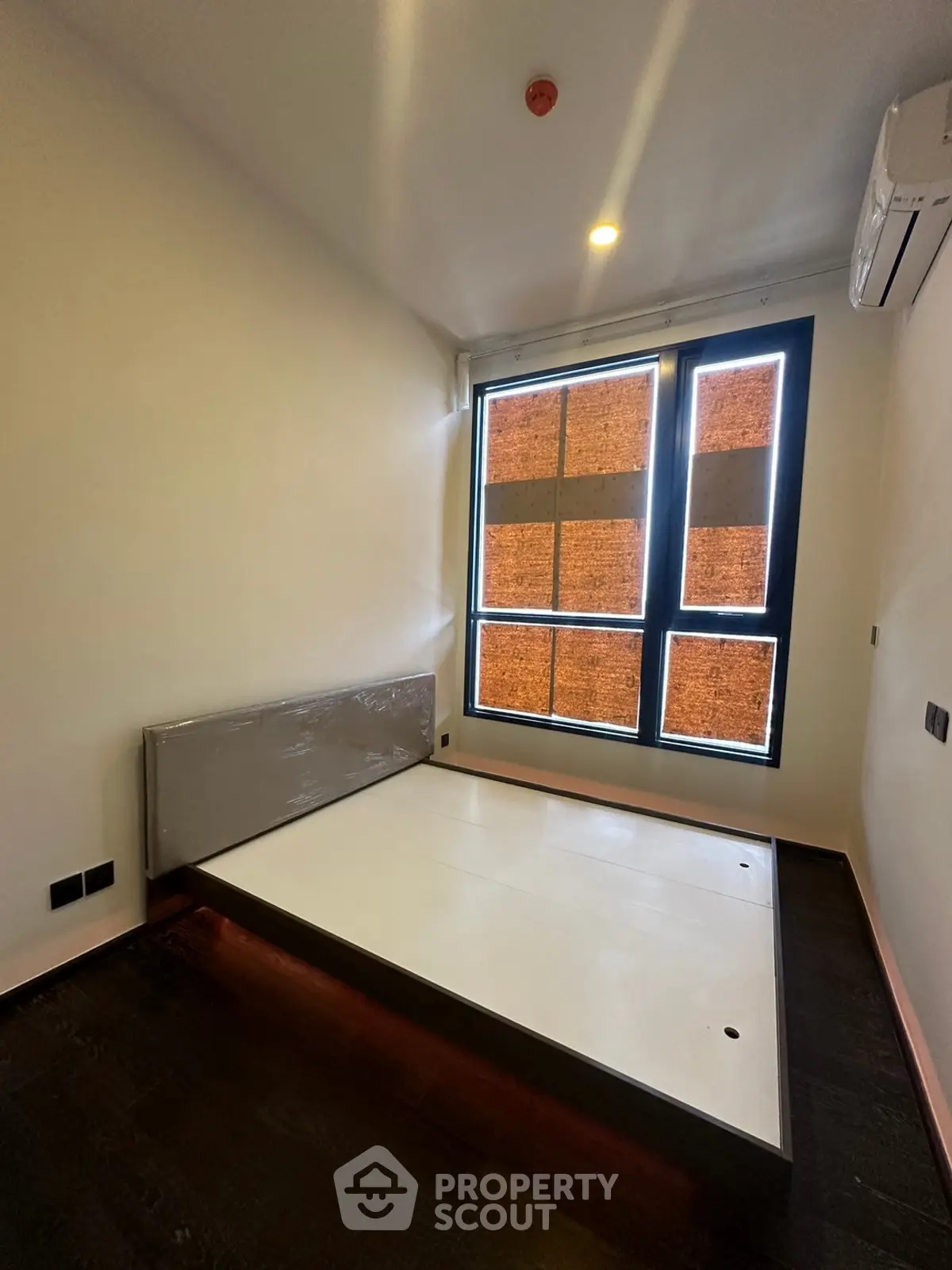 Modern bedroom with large window and minimalist design