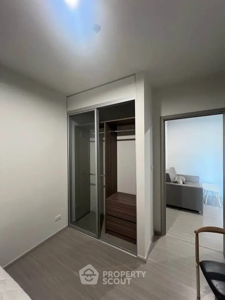 Modern apartment with sleek built-in wardrobe and cozy living area