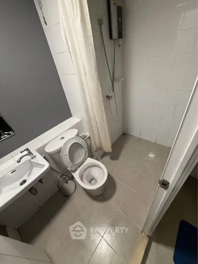 Compact bathroom with modern fixtures and shower area