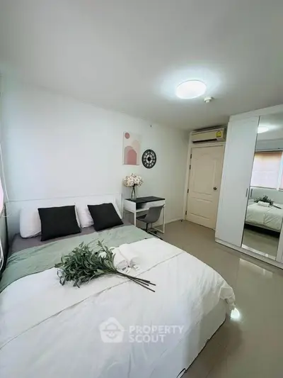 Modern bedroom with stylish decor and ample storage in a bright, inviting space.
