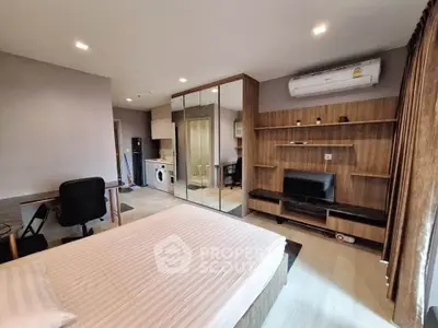 Modern bedroom with mirrored closet and home office setup