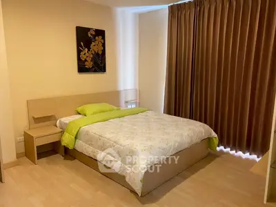 Cozy bedroom with modern decor and natural light, featuring a comfortable bed and elegant curtains.