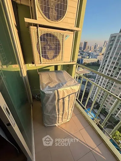 High-rise balcony with city view and air conditioning units, perfect for urban living.