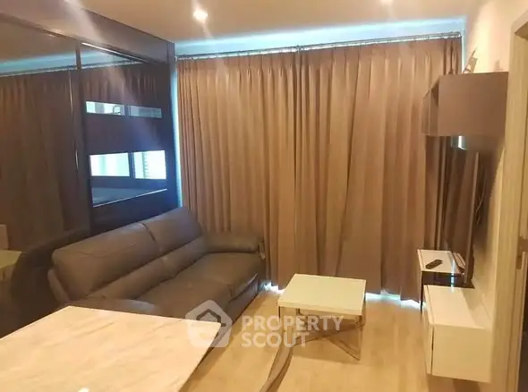 Modern living room with sleek furniture and floor-to-ceiling curtains